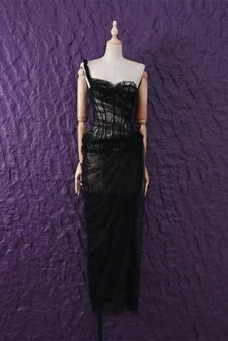 Black evening gown on a mannequin against a textured purple wall