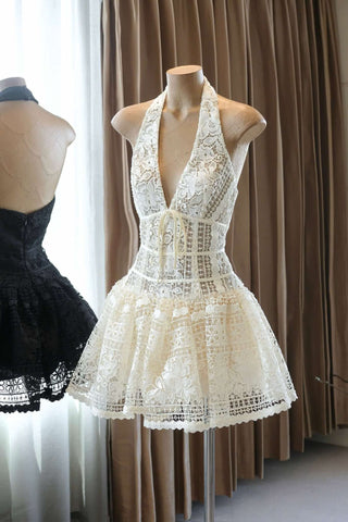 White lace dress on a mannequin against a curtain backdrop