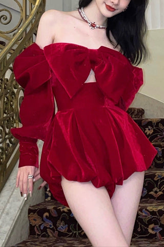 Woman in a red dress standing on a staircase