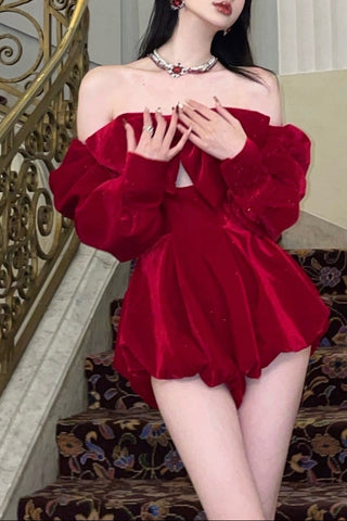 Woman in a red dress standing on a staircase in an elegant interior setting